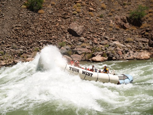 people rafting down a hectic river